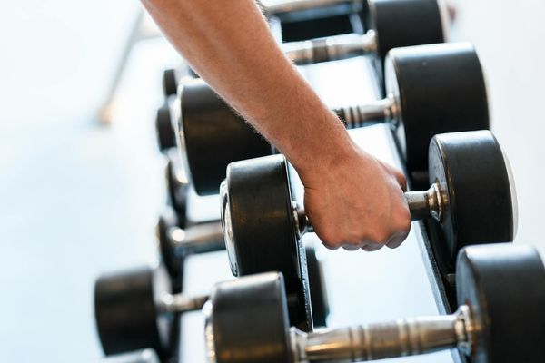 Close-up of a hand gripping a dumbbell.